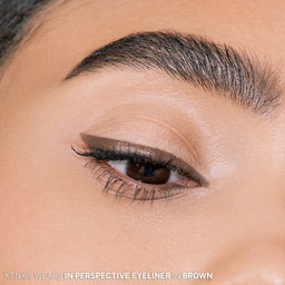 Kenxis wearing in pespective eyeliner in brown in a close up shot showing eye and eyebrow